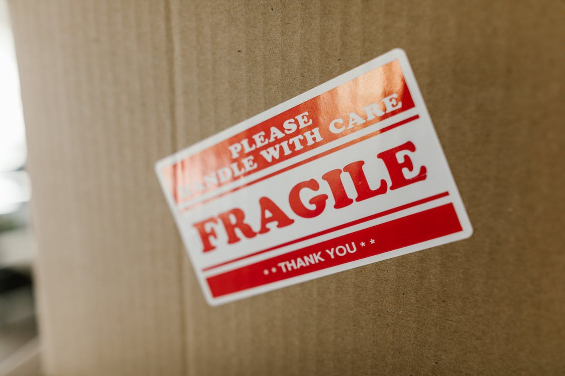 cardboard box with fragile sticker on it